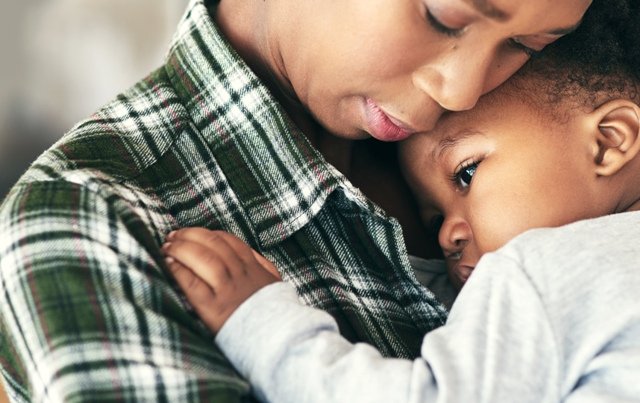 image of young woman holding small infant child