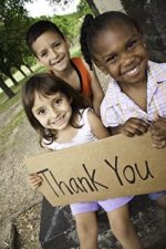 three young children holding large thank you sign