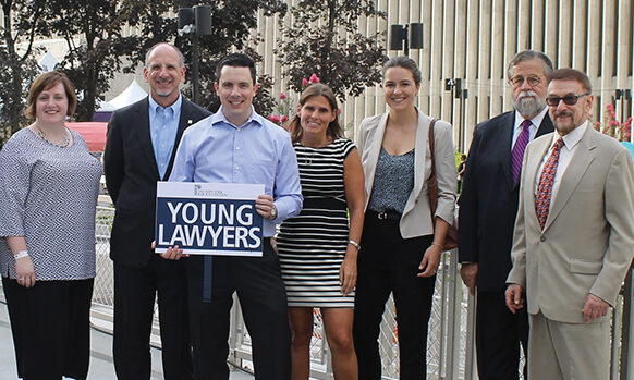 group of young people standing with board members