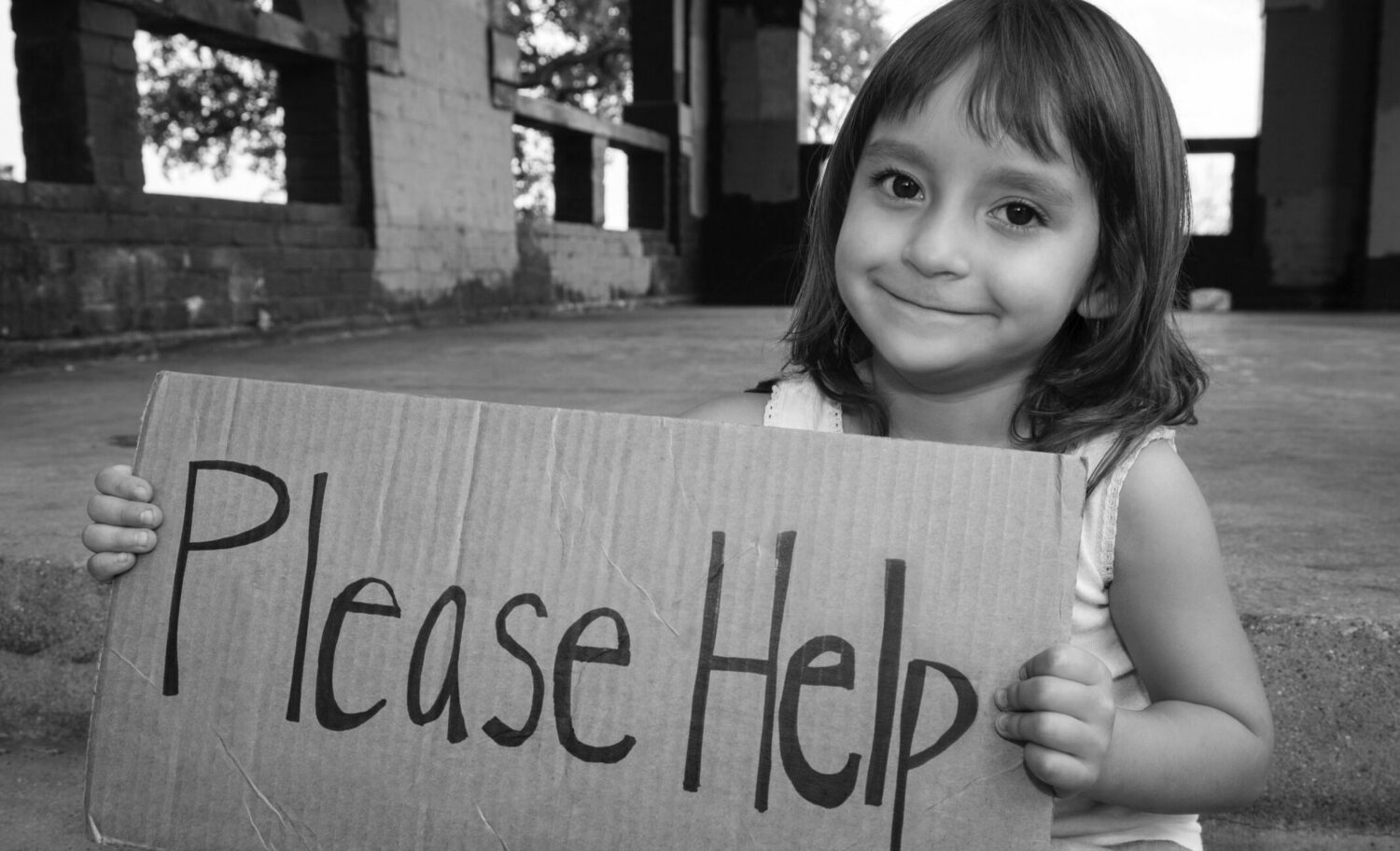 young girl holding Please Help sign