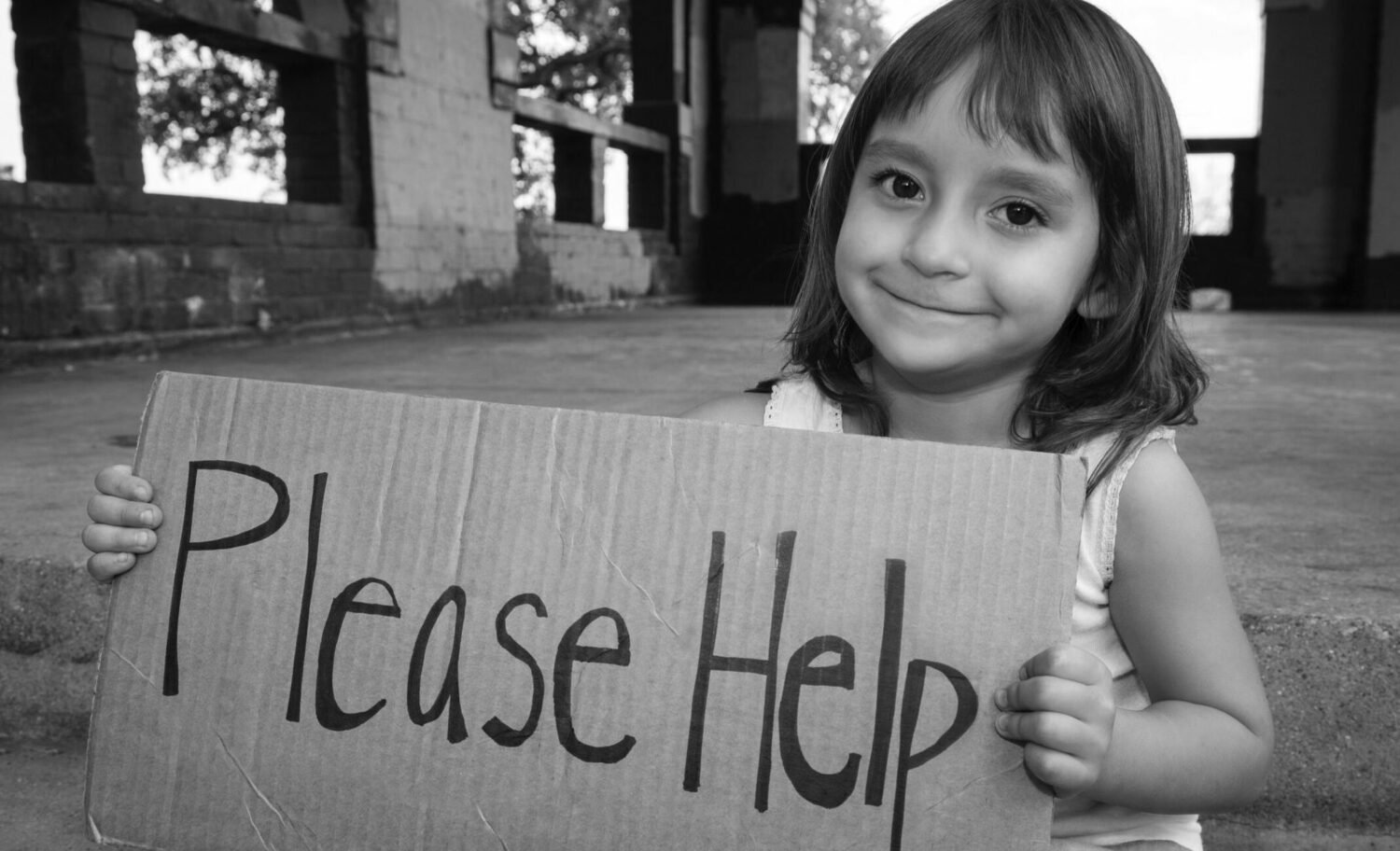 young girl holding Please Help sign