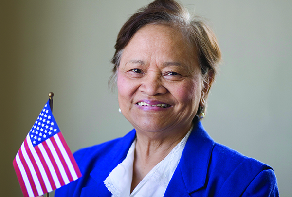elderly woman holding american flag